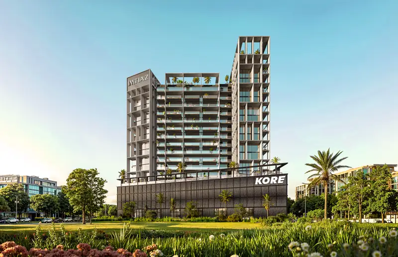 Kore by Imtiaz seen from a landscaped park: stepped towers with planted terraces above a podium signed KORE