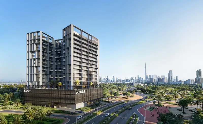 Kore by Imtiaz: grey grid-framed residential building on a dark podium with the Downtown Dubai skyline behind, DLRC